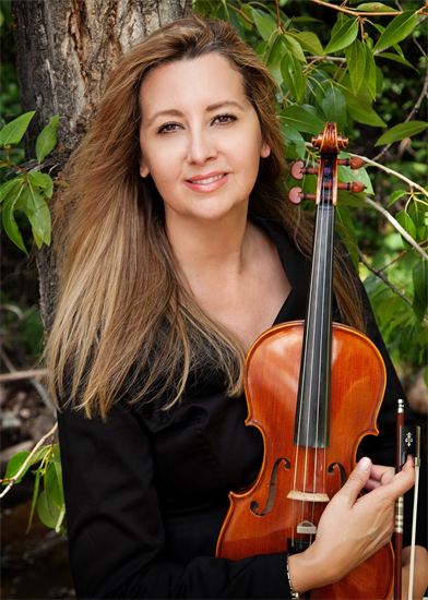 A Picture of Michele holding a Violin